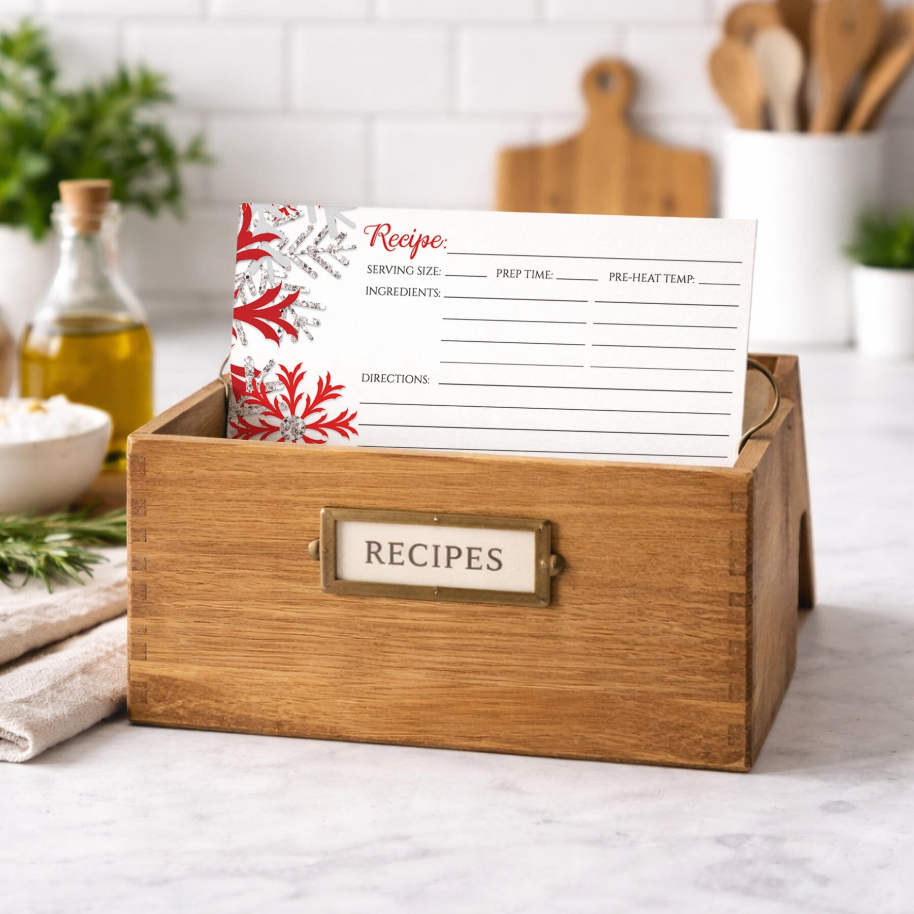 Wooden recipe box with a Winter Red Silver Snowflake Recipe Card inside on a kitchen counter