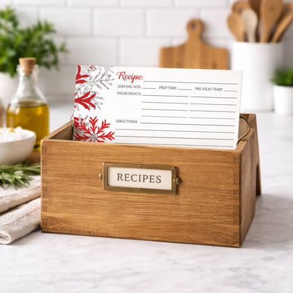 Wooden recipe box with a Winter Red Silver Snowflake Recipe Card inside on a kitchen counter
