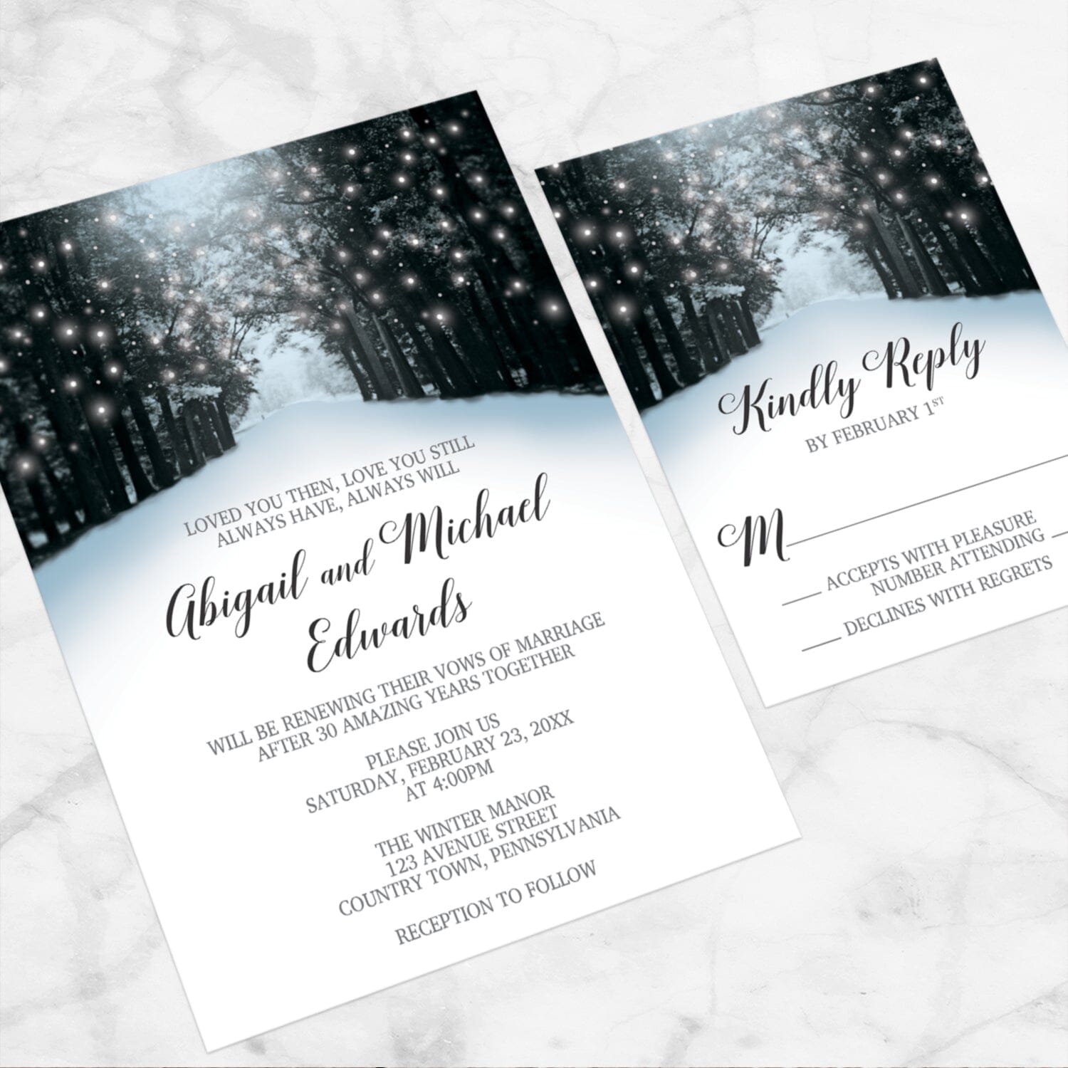 Snowy Winter Road Tree Lights Vow Renewal Invitation shown at an angle on a marble surface with the matching RSVP card.