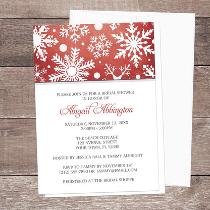Winter Snowflake Red Gray Bridal Shower Invitation shown on a wooden surface with a white envelope.