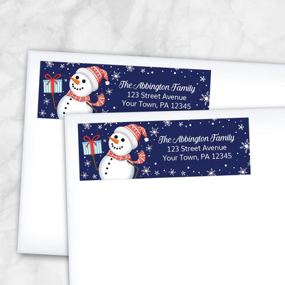 Two Christmas-themed address labels with snowmen on white envelopes