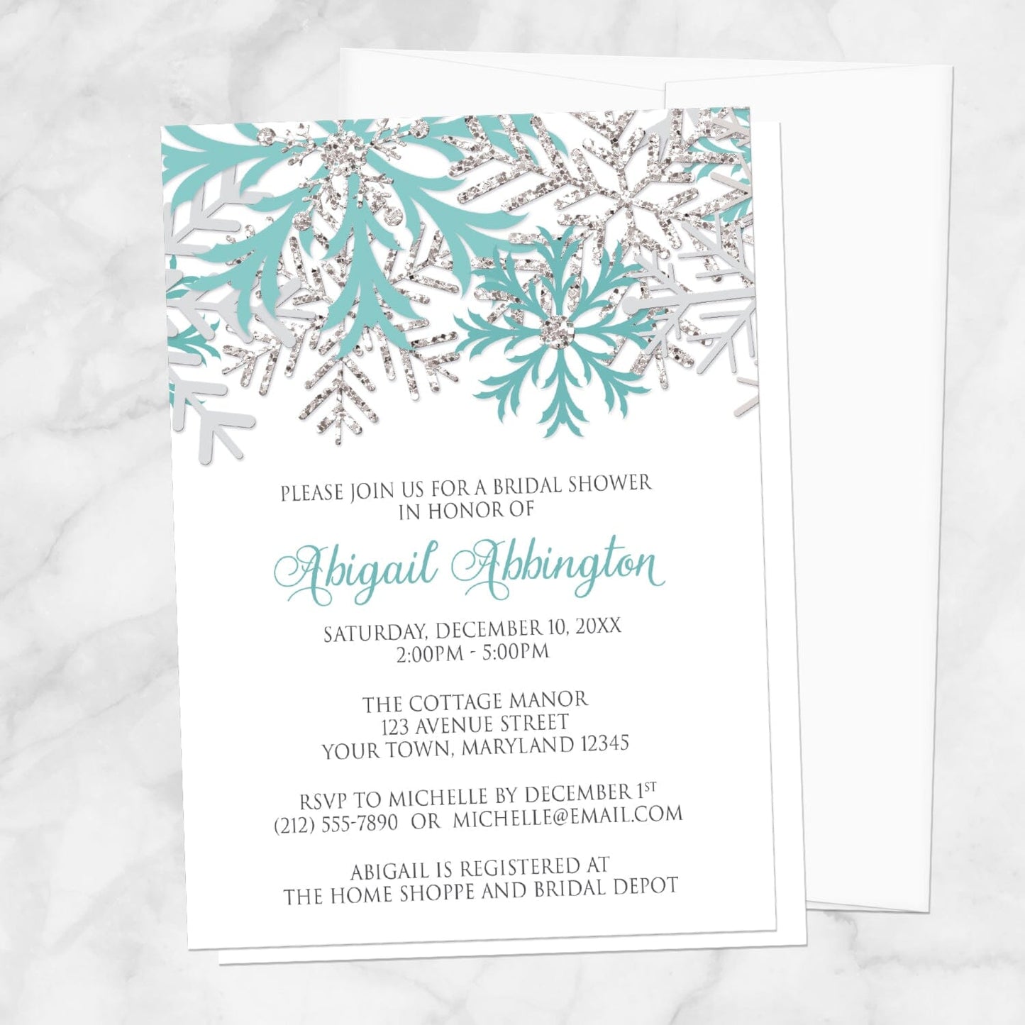Winter Teal Silver Snowflake Bridal Shower Invitation shown with a white envelope on a marble surface.