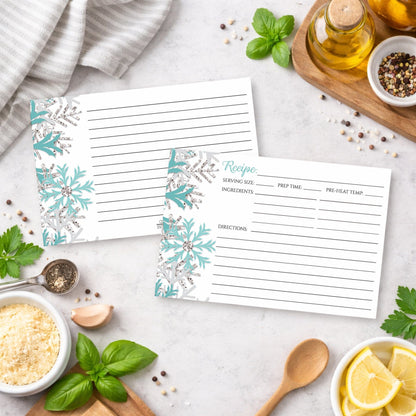 Two Winter Teal Silver Snowflake Recipe Cards on a kitchen counter with ingredients.