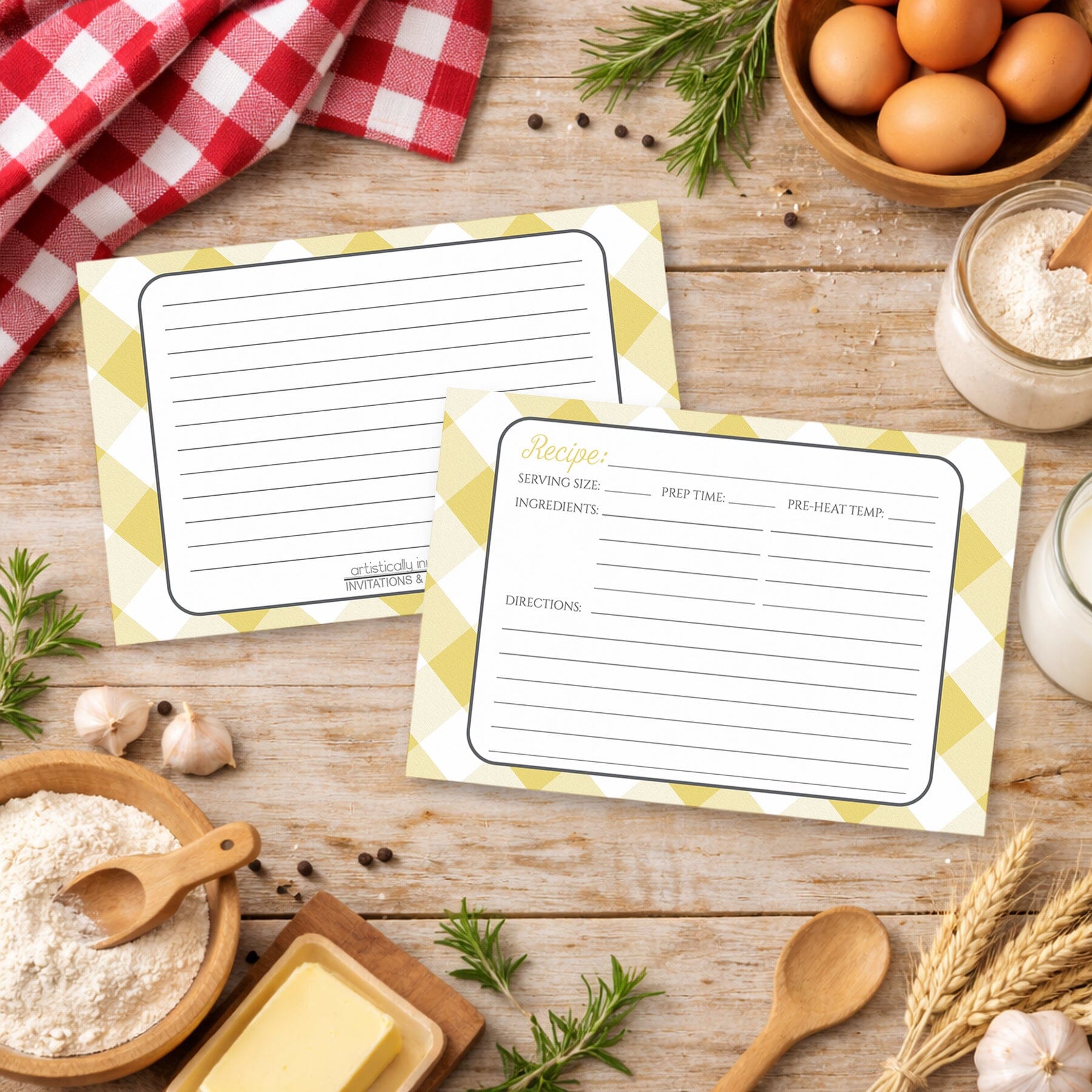 Two Yellow Gingham Recipe Cards on a country wooden surface with cooking ingredients.