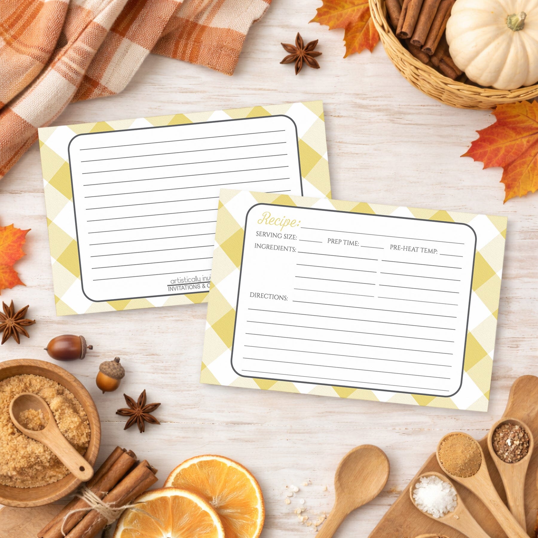 Two Yellow Gingham Recipe Cards on a wooden surface with autumn-themed items.