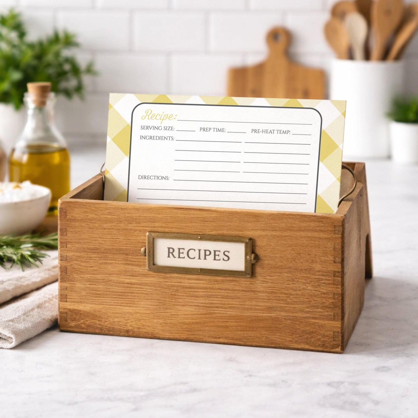 Wooden recipe box with a Yellow Gingham Recipe Card inside on a kitchen counter