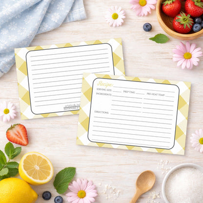 Two Yellow Gingham Recipe Cards on a wooden surface with spring and summer fruits and flowers