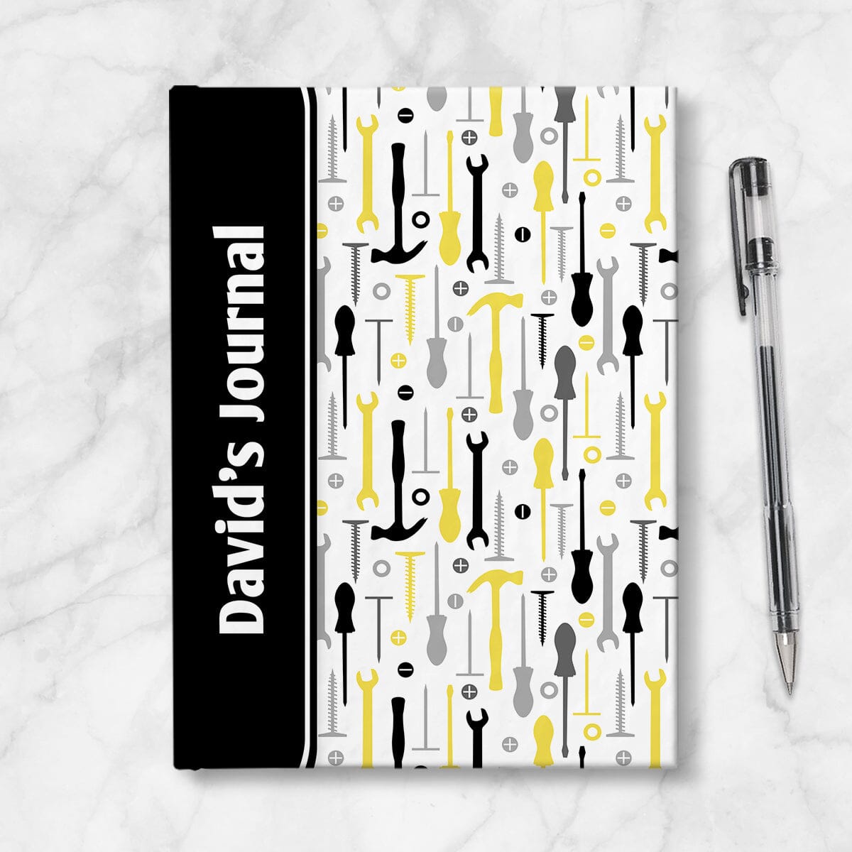 Personalized Yellow Tools Pattern Journal at Artistically Invited. A custom book designed with a black color block wrapping around the spine area over an organized pattern of yellow, black, and gray tools on the rest of the background. This handyman or contractor-inspired pattern includes hammers, screwdrivers, wrenches, nails, screws, and washers. Your personalized name and text of your choice is custom printed sideways in white over the black color block on the front near the spine.
