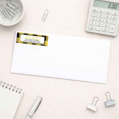 Yellow and Black Buffalo Plaid Address Label shown on a white envelope with everyday office supplies