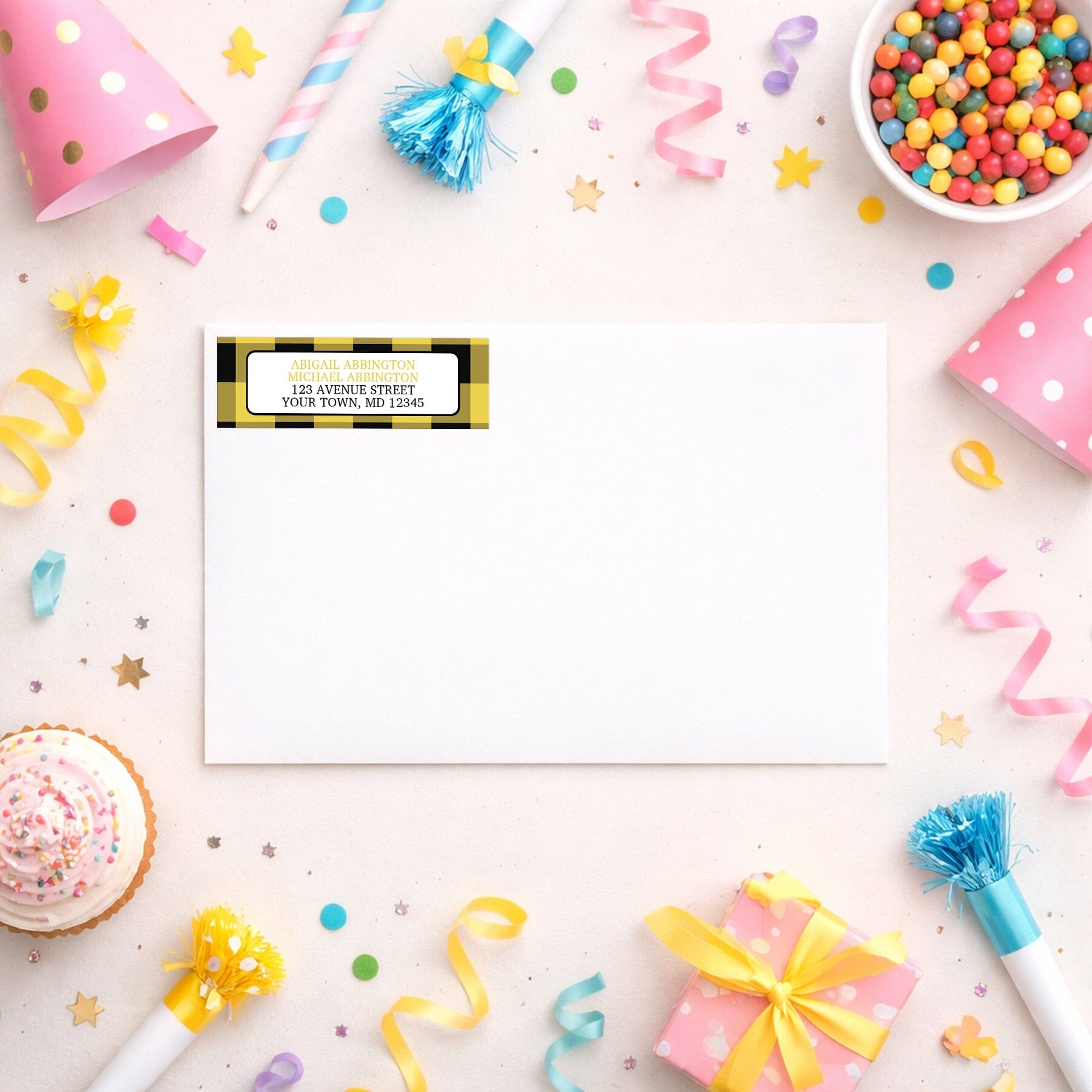 Yellow and Black Buffalo Plaid Address Label shown on a white envelope with party supplies