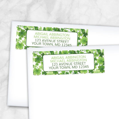 Shamrocks and 4-Leaf Clovers Address Labels at Artistically Invited. Shamrocks and 4-leaf clovers address labels personalized with your return address. These address labels are custom printed with your return address in green inside a white rectangular area outlined in dark green over a gorgeously green pattern design background with shamrocks and 4-leaf clovers in varying sizes and shades of green. Photo shows the labels on envelopes.