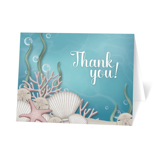 Whimsical Under the Sea Thank You Cards at Artistically Invited. Uniquely illustrated whimsical under the sea thank you cards with an under the sea or aquarium theme. They are designed with an illustration of a sandy seabed, assorted seashells, coral, and kelp. This underwater design has an aqua blue water background. It's sprinkled with some whimsical bubbles to add some whimsical fun.